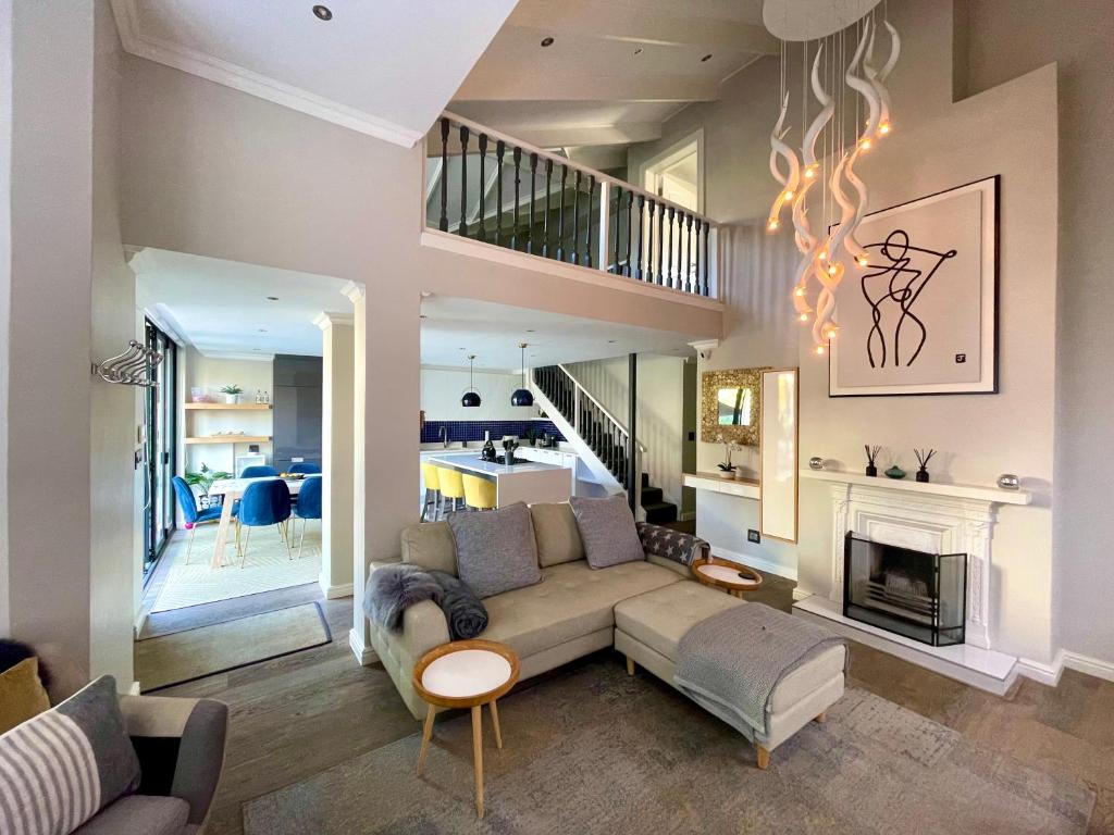 a living room with a couch and a fireplace at Atlantic Cove in Cape Town