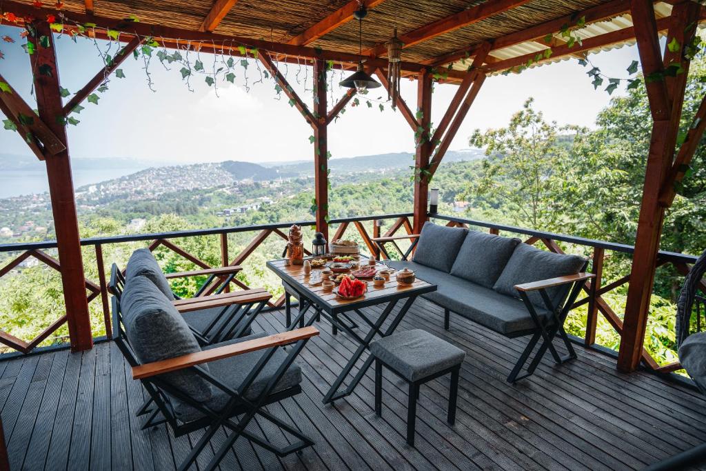 a wooden deck with a table and chairs on it at Bungalow green love sapanca in Sapanca