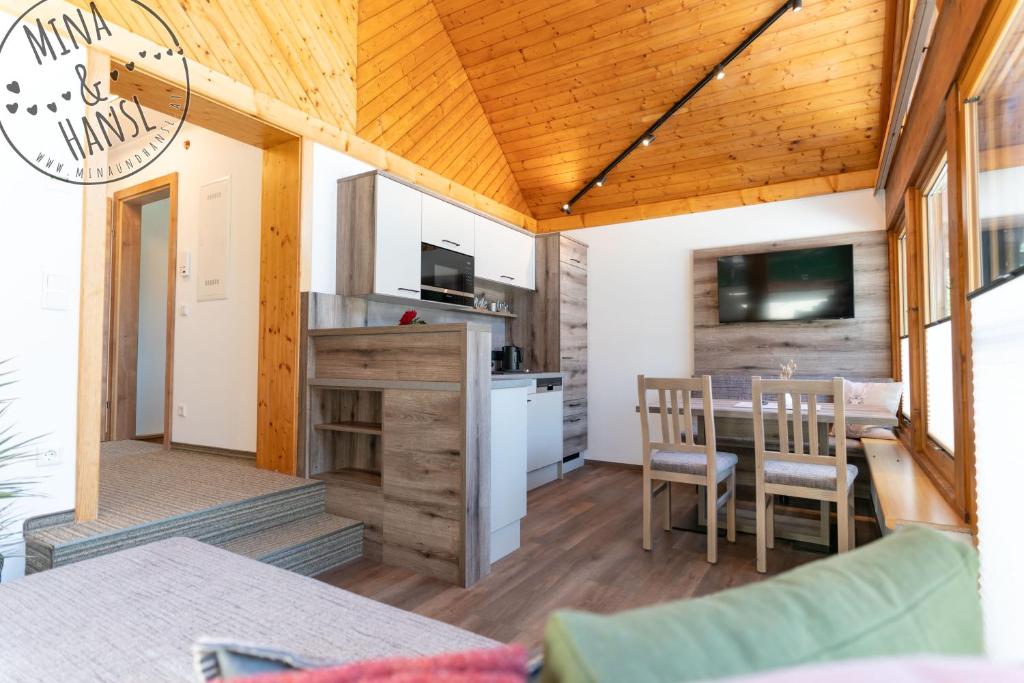 a kitchen and dining area of a tiny house at Mina&Hansl in Schladming