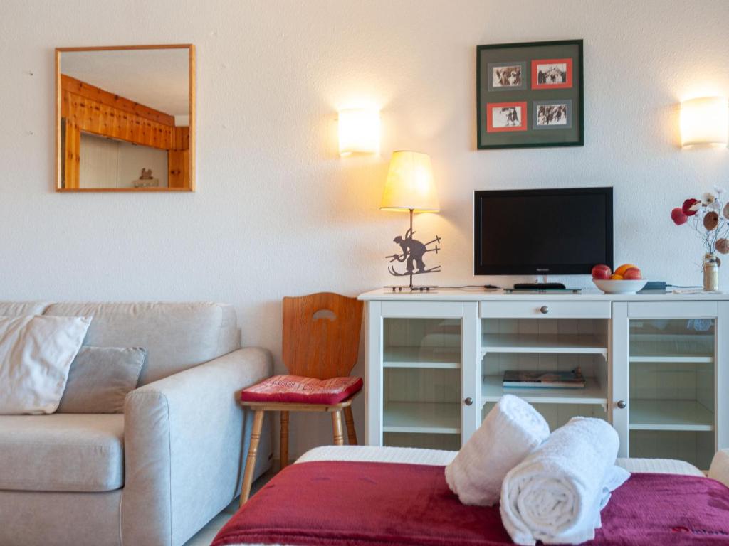 a living room with a couch and a tv at Apartment Christiania 2 O1 by Interhome in Nendaz