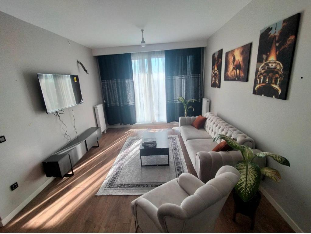 a living room with a couch and a tv at luxury family 2+1 apt in toya next Residence in Istanbul