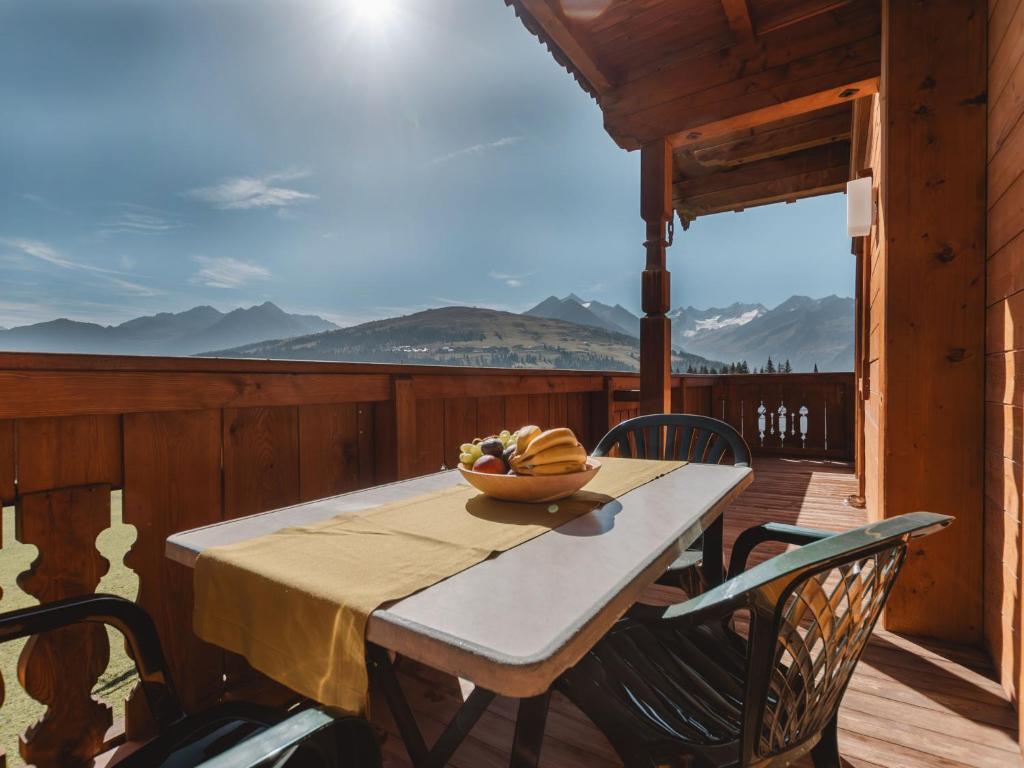 a table on a deck with a bowl of bananas on it at Apartment Voithofer-1 by Interhome in Königsleiten