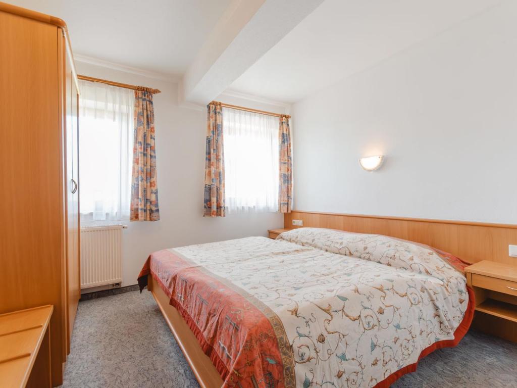 A bed or beds in a room at Apartment Voithofer-7 by Interhome