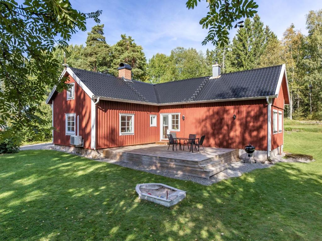 una casa rossa con patio e cortile di Holiday Home Aspenäs by Interhome a Falköping