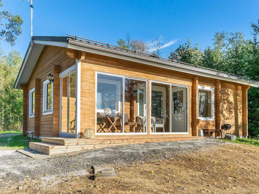 a small house with a large glass door at Holiday Home Jussinlahti by Interhome in Kortteinen