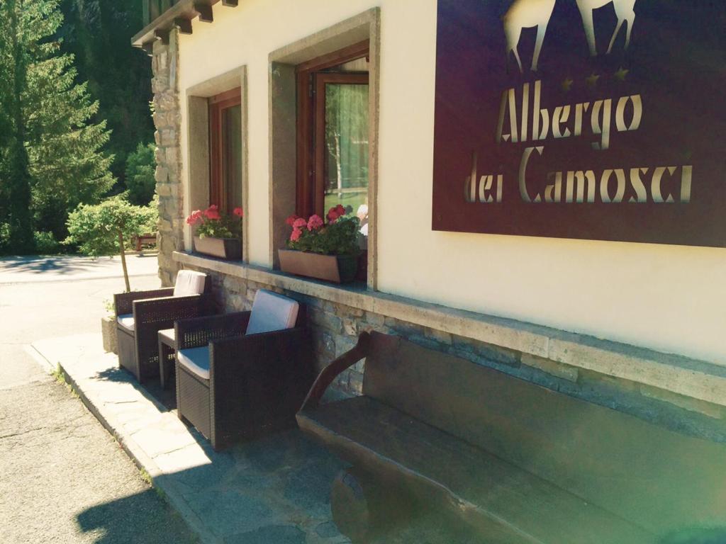 a group of benches outside of a building at Hotel Dei Camosci in Courmayeur