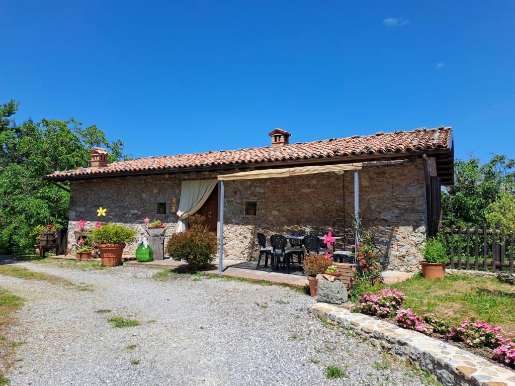 a stone house with a patio in a yard at Apartment Le Bore-1 by Interhome in Sassi