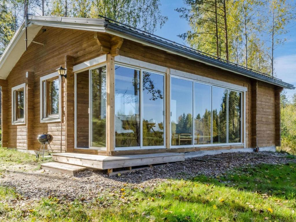 a house with large glass windows on the side of it at Holiday Home Koskisaari by Interhome in Kortteinen