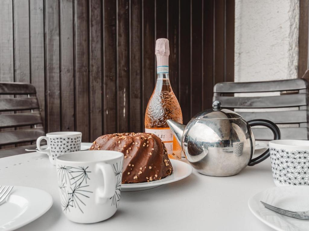a table with a cake and a bottle of champagne at Apartment Sonnenappartements by Interhome in Bad Hofgastein