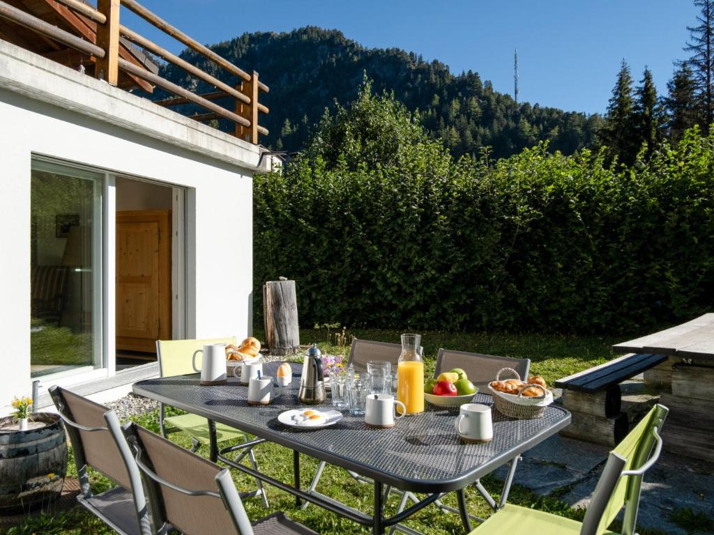 a table with food and drinks on a patio at Chalet Mon Rêve by Interhome in Champex