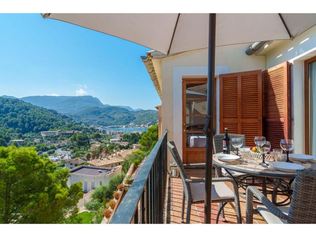 a balcony with a table and chairs and an umbrella at Apartment S'Atalaia Sea Views by Interhome in Port de Soller