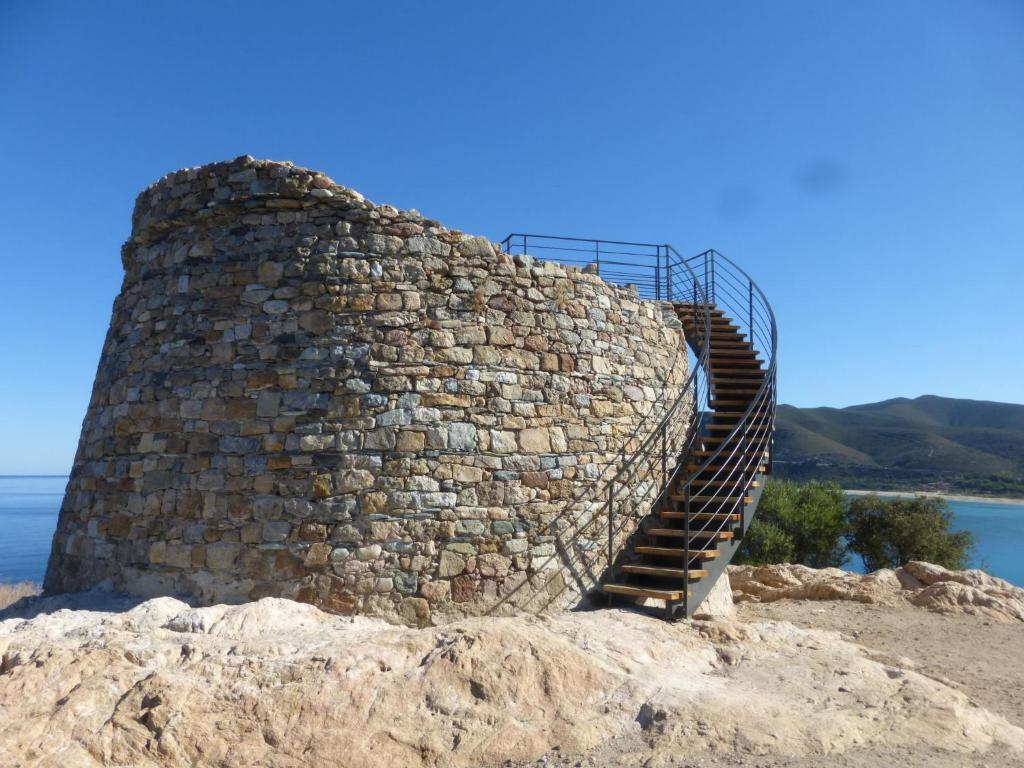 a stone staircase on top of a rock wall at Holiday Home Chez Béatrice et Pascal by Interhome in Belgodère
