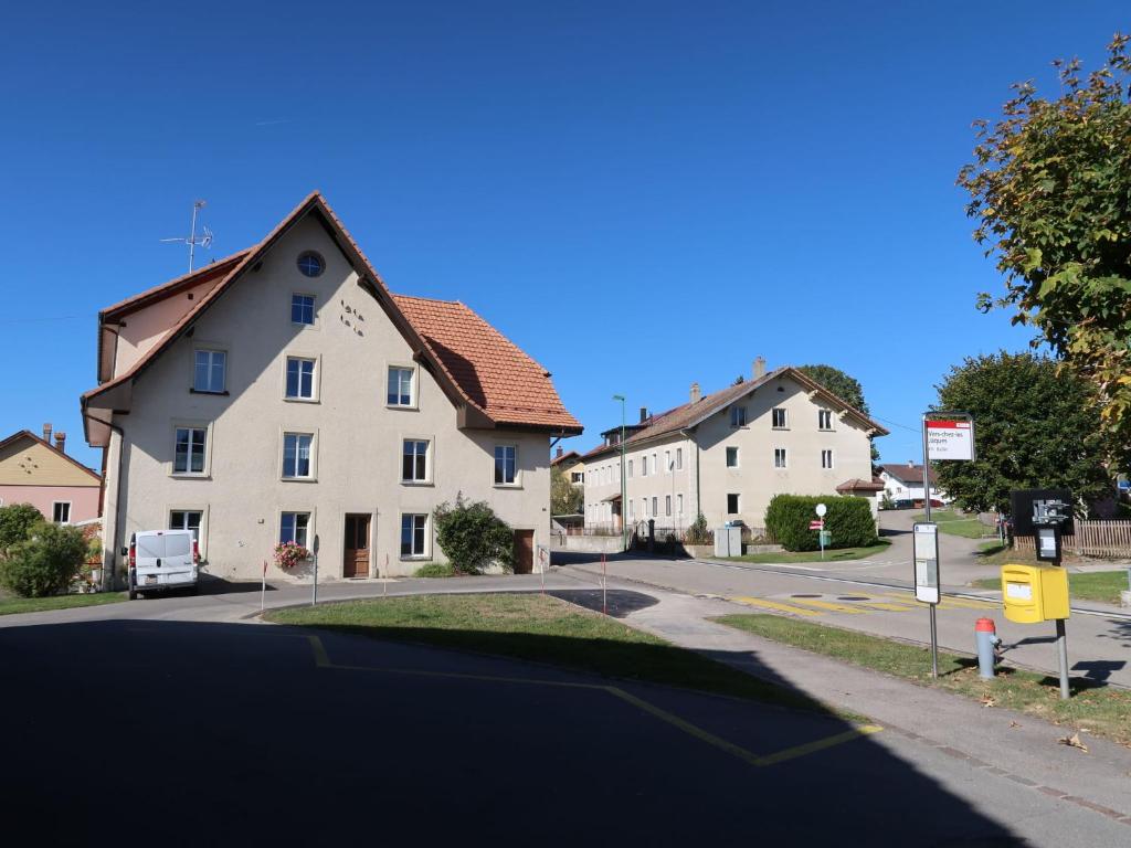 a street with two houses on a street at Apartment Grand-Rue 143 by Interhome in Auberson