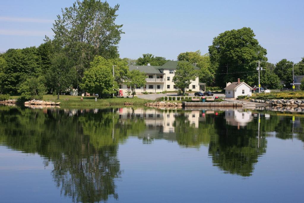 a view of a lake with houses in the background at Lanes Privateer Inn in Liverpool