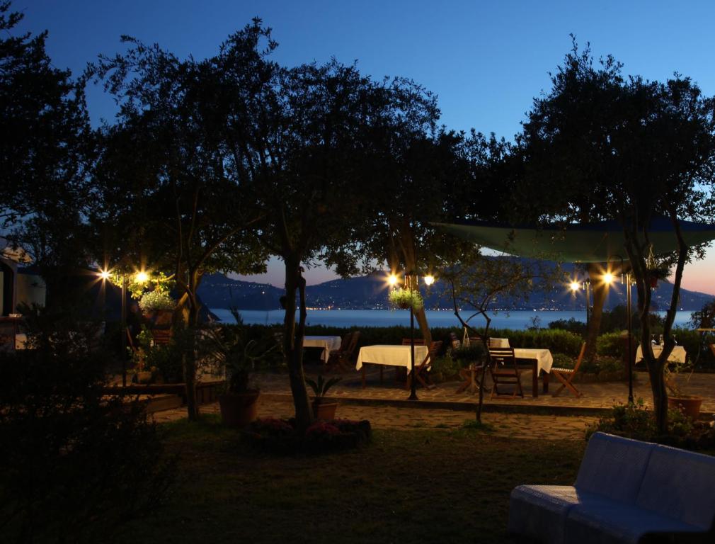 a night view of a patio with tables and lights at Solcalante in Procida