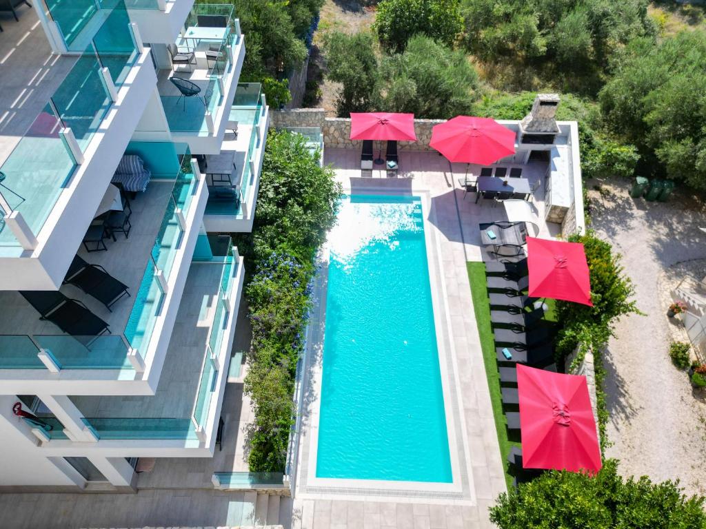 an aerial view of a pool with red umbrellas at Villa Aqua in Zaboric