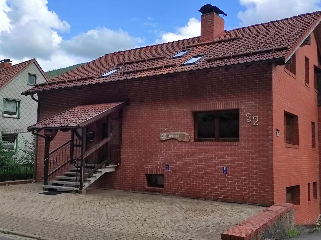 a brick building with a staircase on the side of it at Gästehaus Harzklause 6 in Sieber