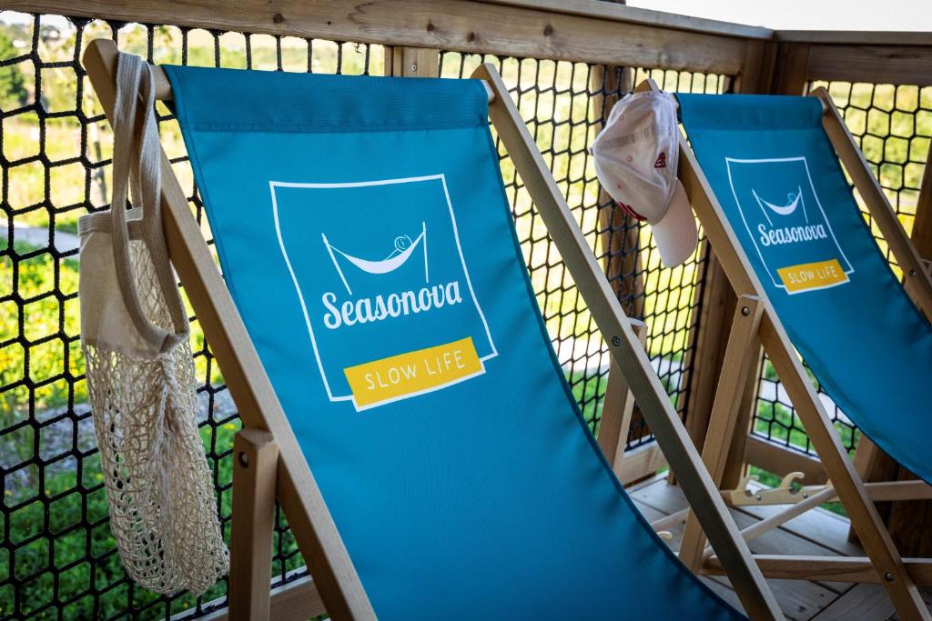 two folding beach chairs with a blue towel on them at DOMAINE SAÂNE ET MER in Quiberville