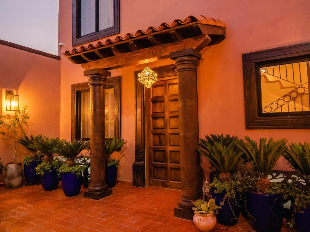 een toegang tot een gebouw met potplanten bij Casamada Residences in Guanajuato