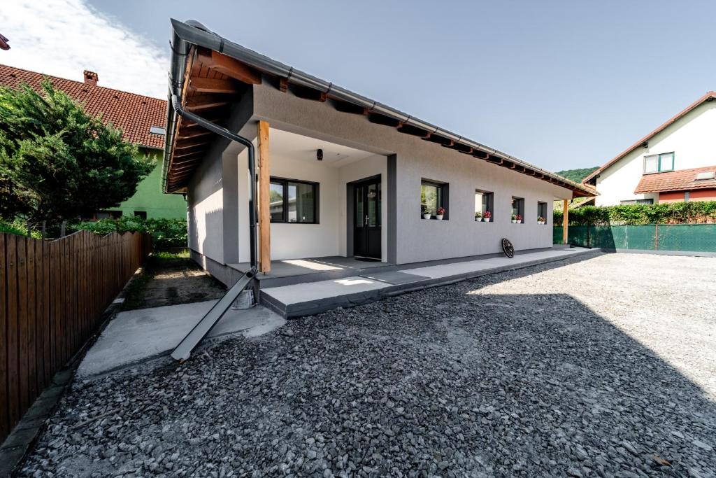 a house with a driveway in front of it at Kata Kulcsosház in Odorheiu Secuiesc