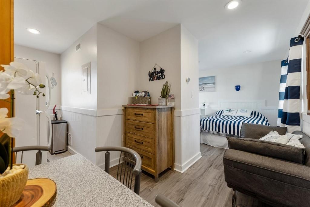 a living room with a bed and a couch at 415 E Atlanta Ave, Unit 107 in Wildwood Crest