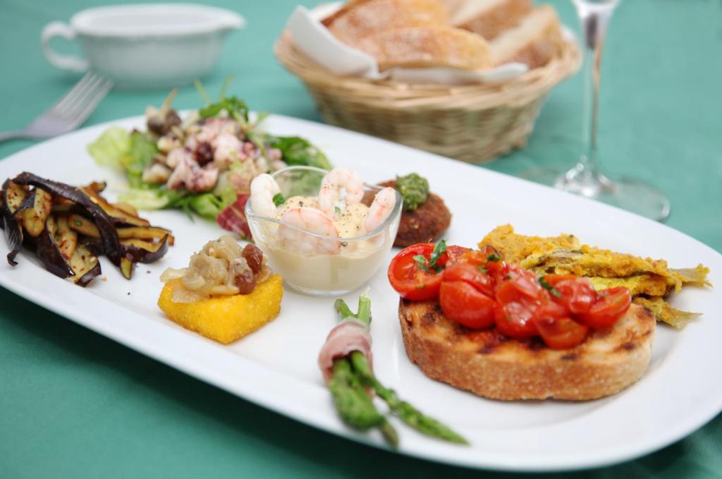 a white plate of food on a table at Solcalante in Procida