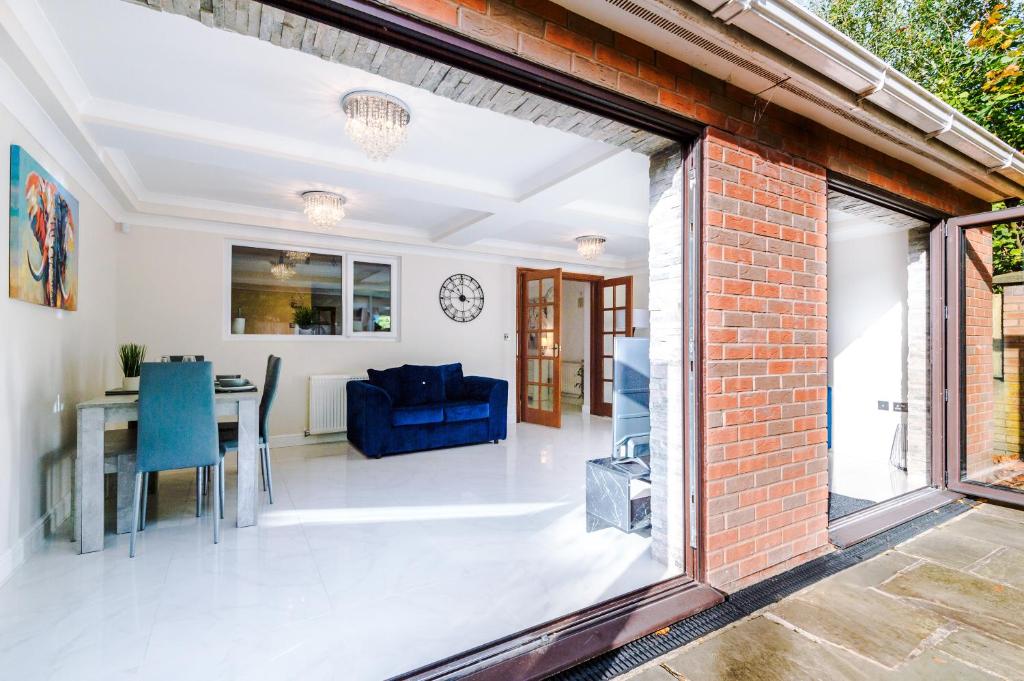 an open living room and dining room with a brick wall at Detached 5 bed House in Worsley Manchester in Worsley