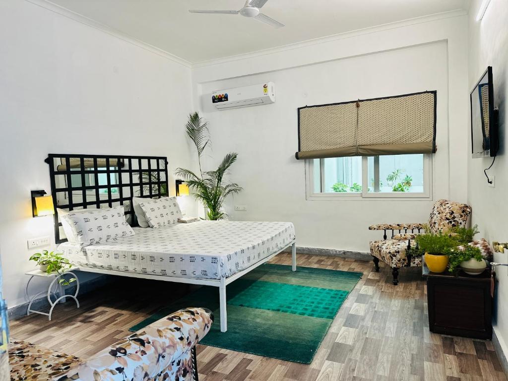 a white room with a bed and a couch at AnandMai - Sustainable Living Spaces in Jaipur