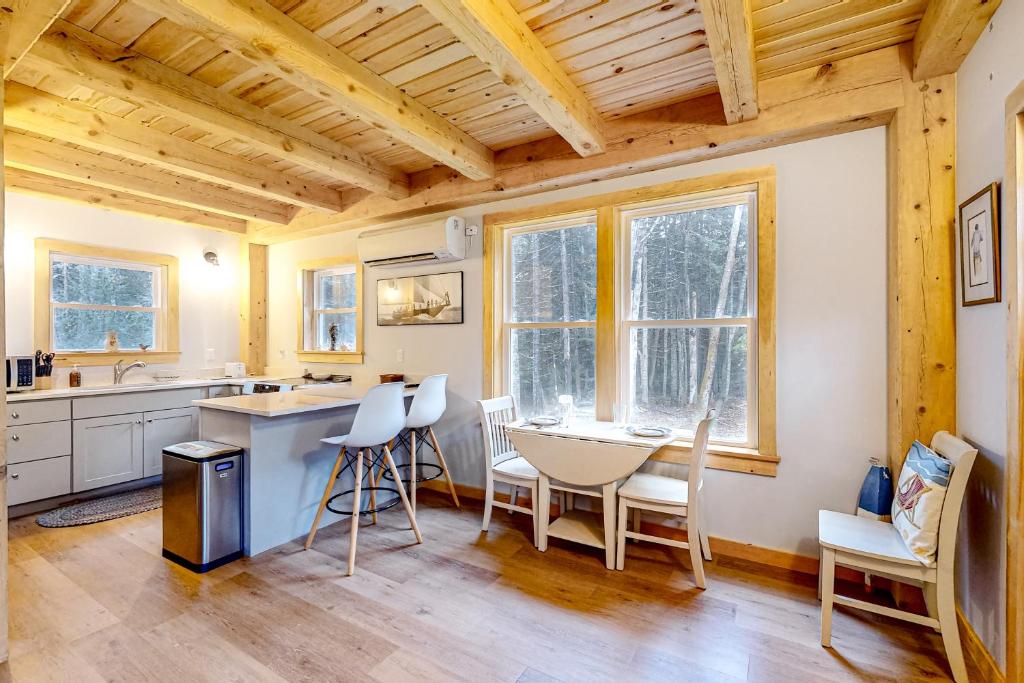 a kitchen with a table and chairs in a room at Cooper Cottage in Boothbay Harbor