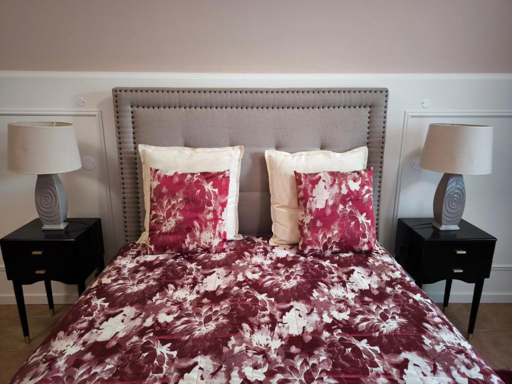 a bedroom with a bed with two lamps on tables at Casa do Limoeiro - Casa in Golegã