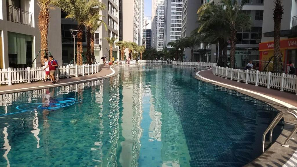 a large swimming pool in a city with buildings at Park 12 Homestay in Hanoi