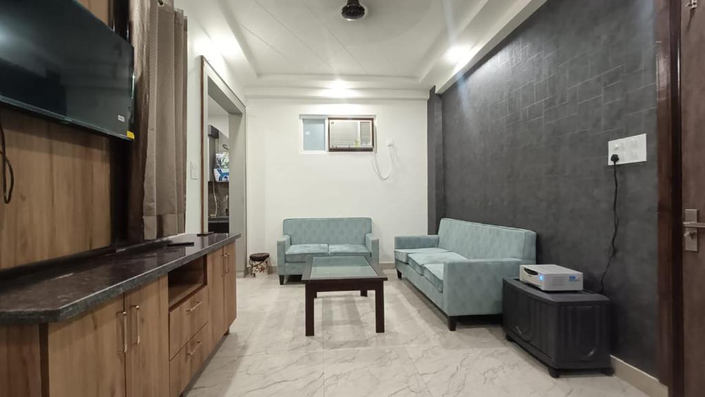 a living room with two chairs and a couch at 85 The Ganges 2 BHK Apartment for Homestay in Rishīkesh