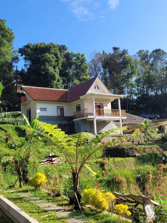 a house in the middle of a garden at Villa Bumisoka in Purwakarta