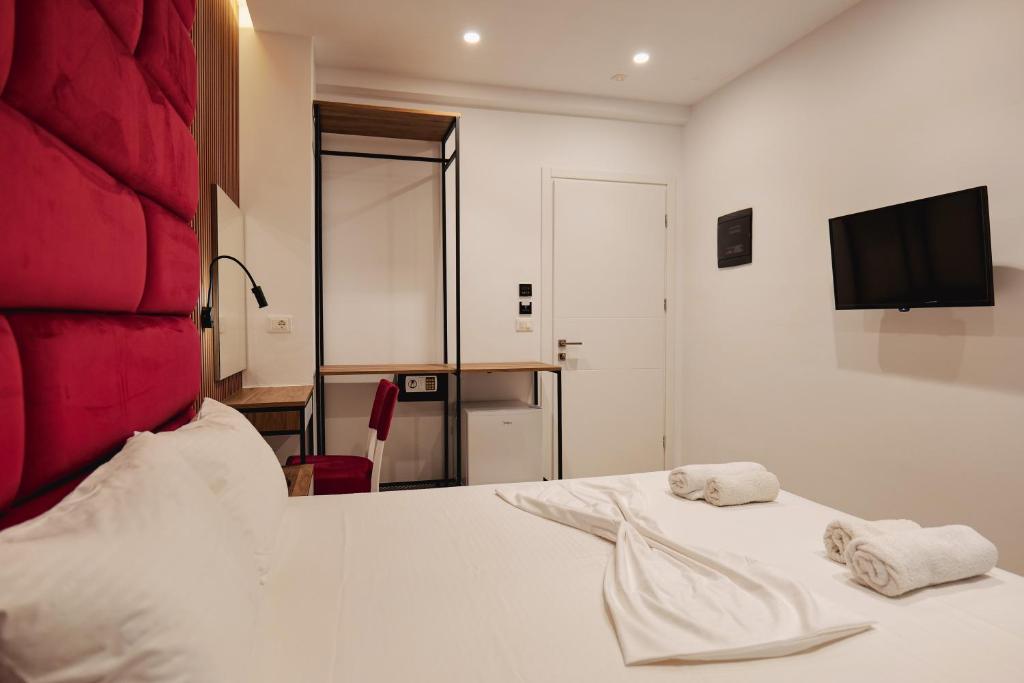 a bedroom with a bed with two towels on it at Vila Shpetimi in Ksamil