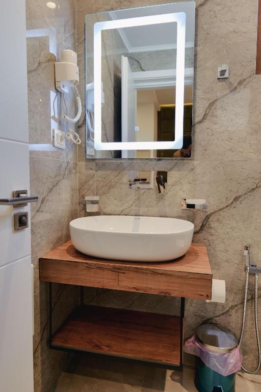 a bathroom with a sink and a mirror at Vila Shpetimi in Ksamil