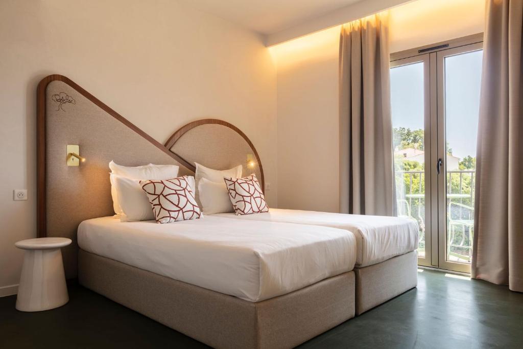 Postel nebo postele na pokoji v ubytování Hôtel du Parc Cavalaire sur Mer