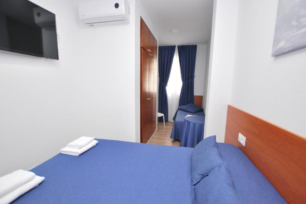 Posteľ alebo postele v izbe v ubytovaní Hotel Tres Leones