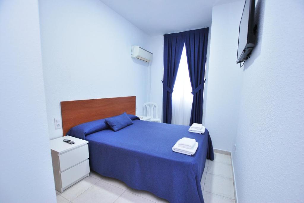 Posteľ alebo postele v izbe v ubytovaní Hotel Tres Leones