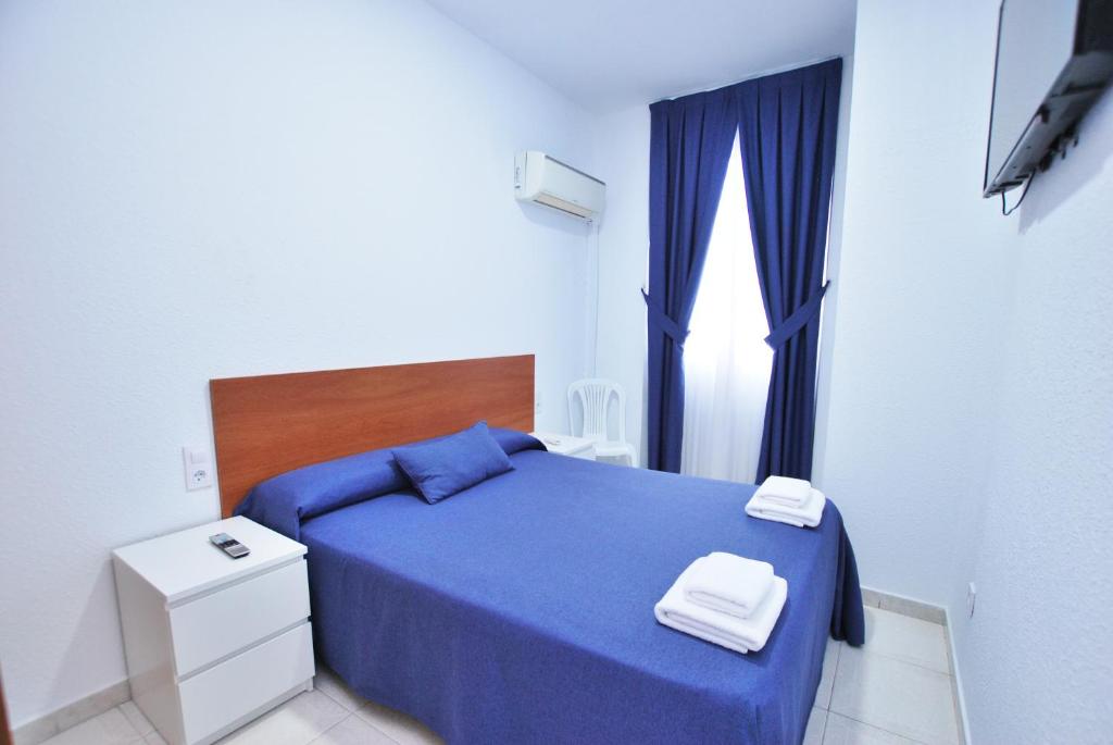 Posteľ alebo postele v izbe v ubytovaní Hotel Tres Leones