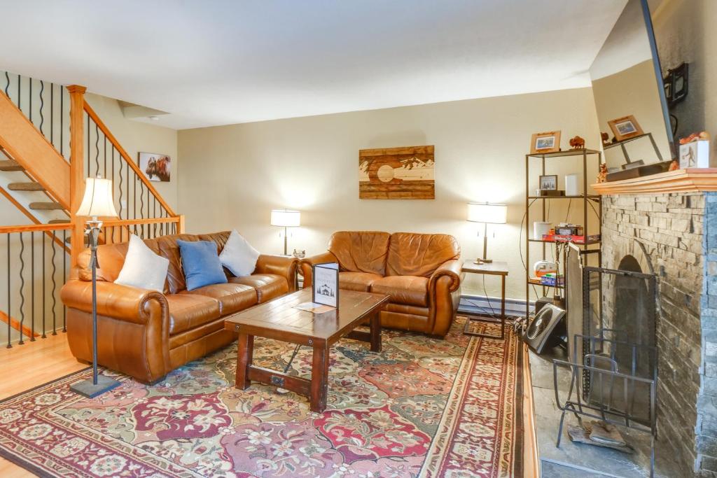 a living room with a couch and a fireplace at Ski-In Retreat with Pool Access 2 Blocks to Main St in Breckenridge