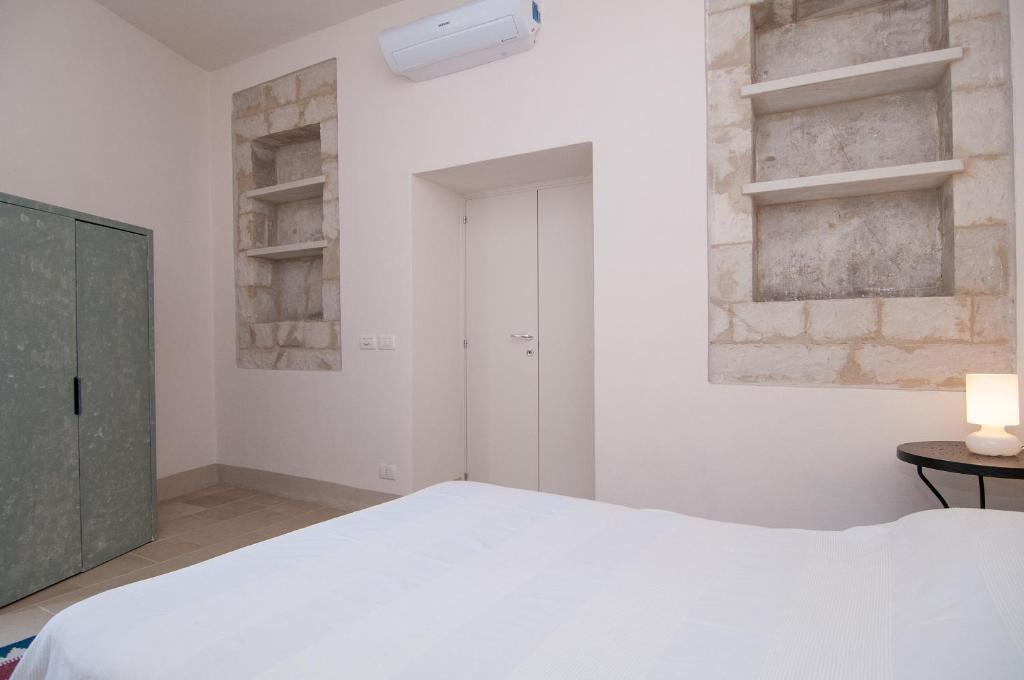 Posteľ alebo postele v izbe v ubytovaní Palazzo Degli Olivi