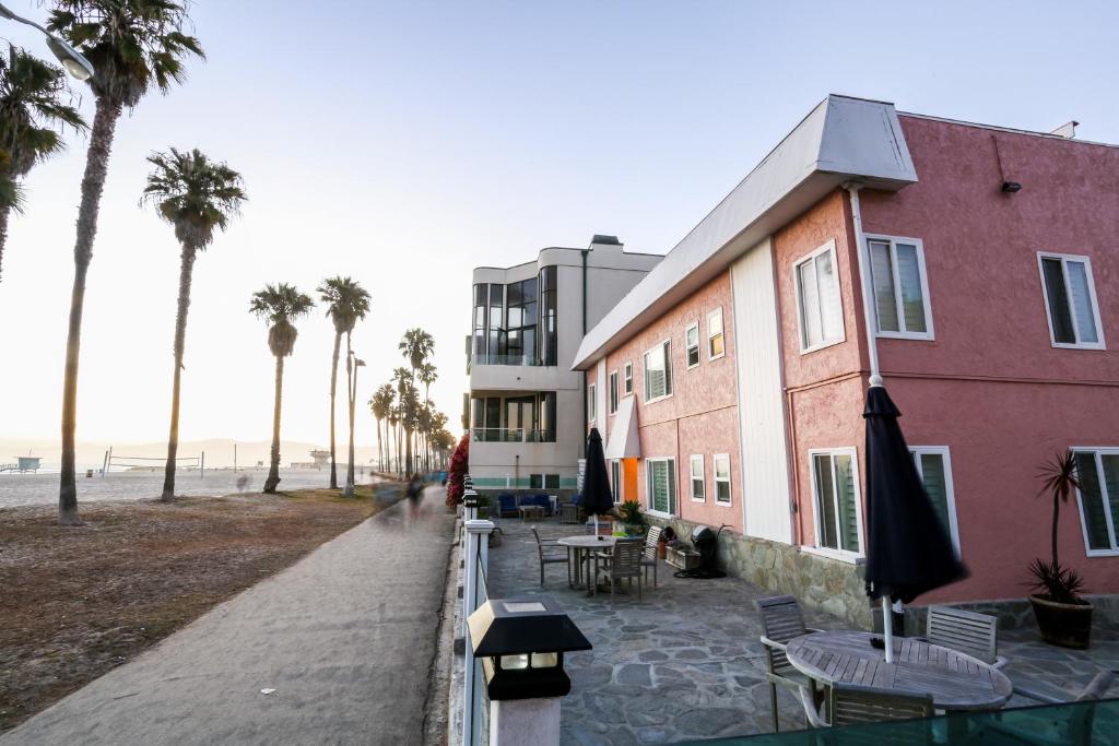 a building next to a beach with palm trees at Venice on the Beach Hotel in Los Angeles
