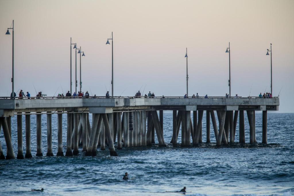 a pier with people on it in the water at Venice on the Beach Hotel in Los Angeles