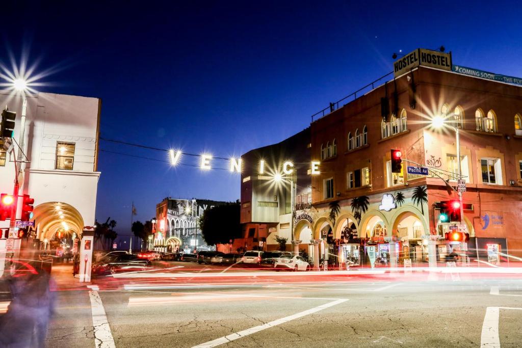 a city street at night with traffic lights and buildings at Venice on the Beach Hotel in Los Angeles