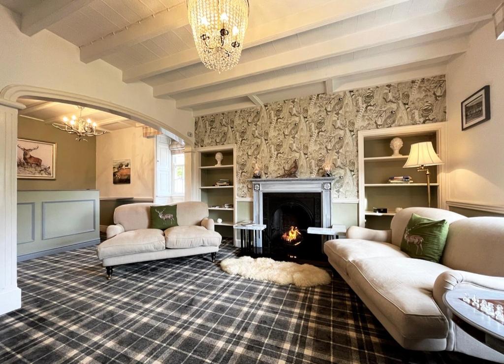a living room with two couches and a fireplace at Burnley country house in Hutton le Hole