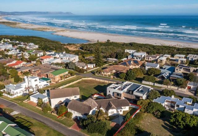 an aerial view of a houses and the beach at Lala Panzi - Grotto Beach, Voëlklip in Hermanus