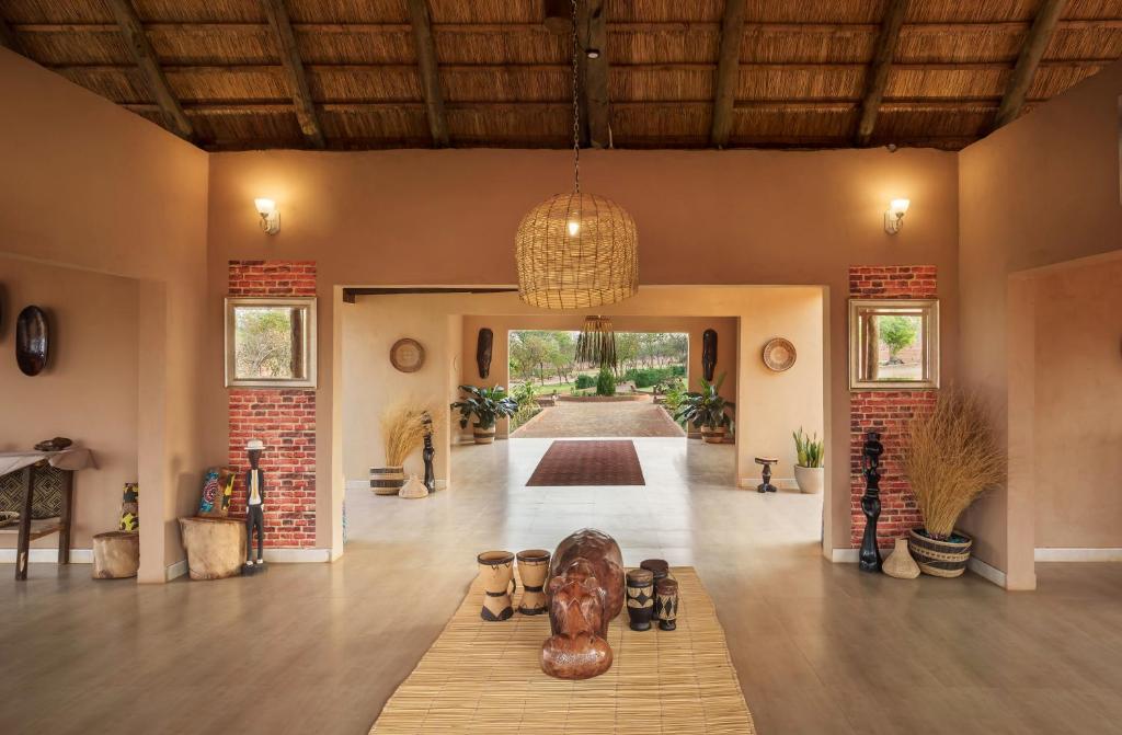 a large living room with a table in the middle at The Nkhosi Livingstone Lodge and Spa in Livingstone