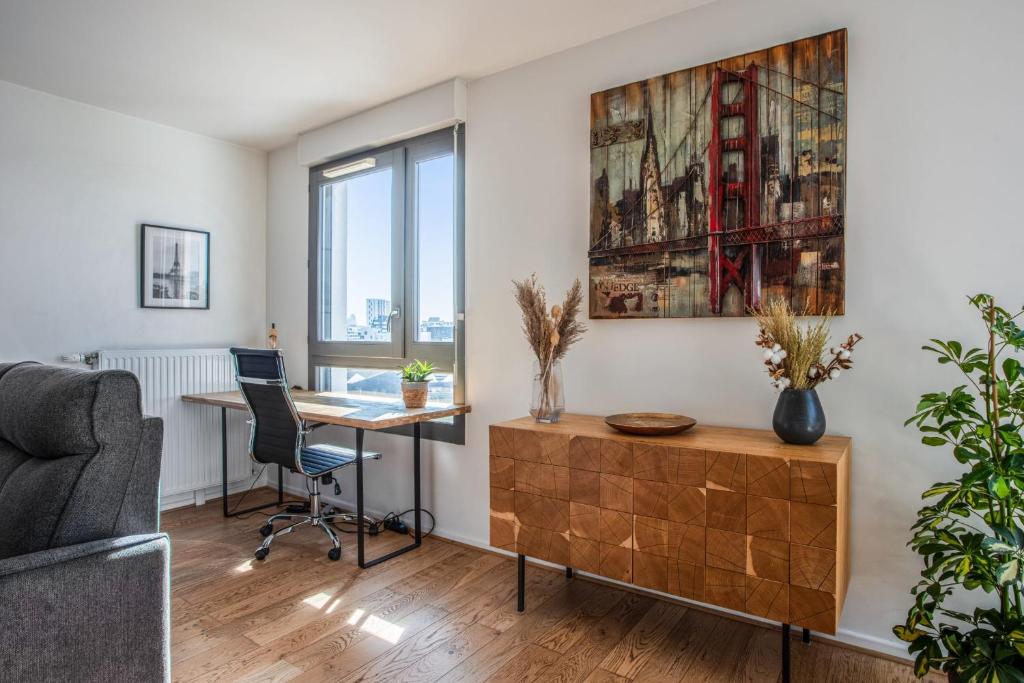 a living room with a desk and a couch at Comfortable flat w views of Paris in Saint-Denis - Welkeys in Saint-Denis