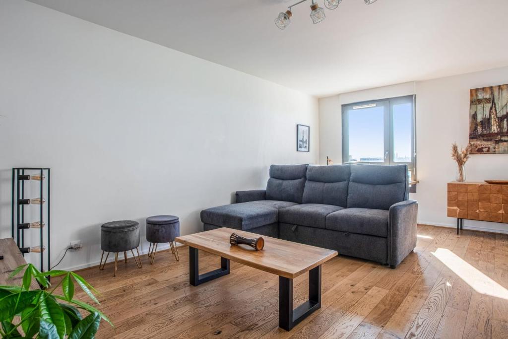 a living room with a couch and a coffee table at Comfortable flat w views of Paris in Saint-Denis - Welkeys in Saint-Denis