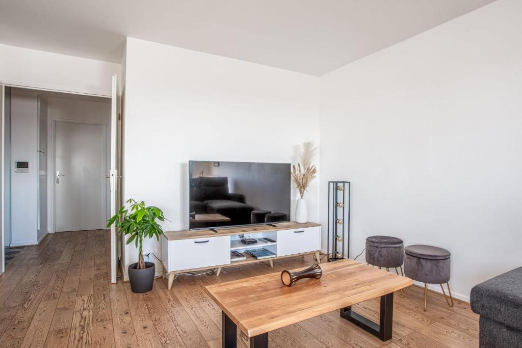 a living room with a couch and a table at Comfortable flat w views of Paris in Saint-Denis - Welkeys in Saint-Denis